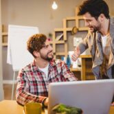 graphic-designer-using-laptop-with-his-coworker_107420-42626 web designer