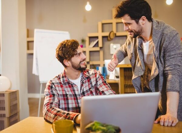 graphic-designer-using-laptop-with-his-coworker_107420-42626 web designer